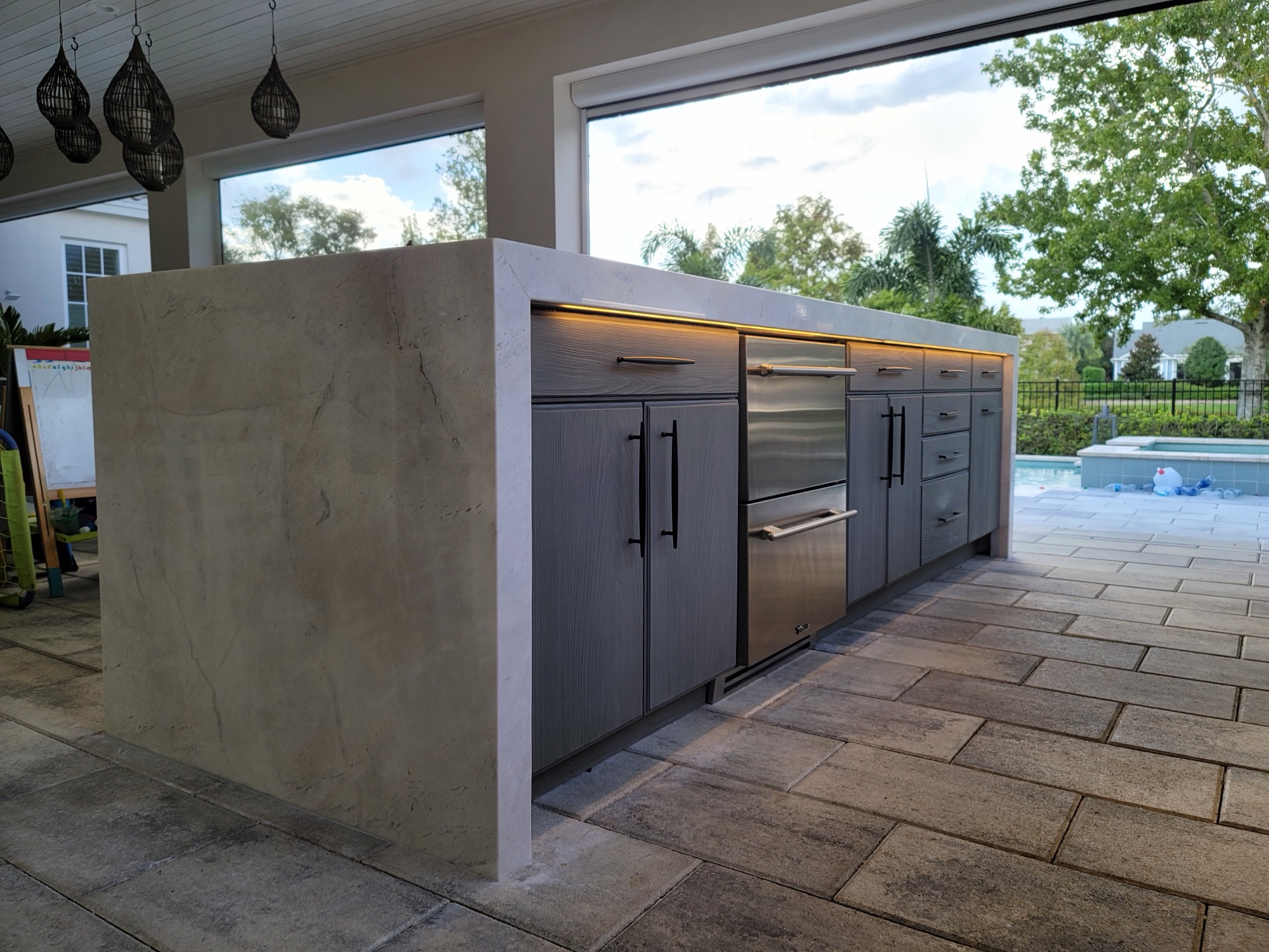 A wider view of the outdoor kitchen on the lanai in Baldwin Park, Orlando, FL