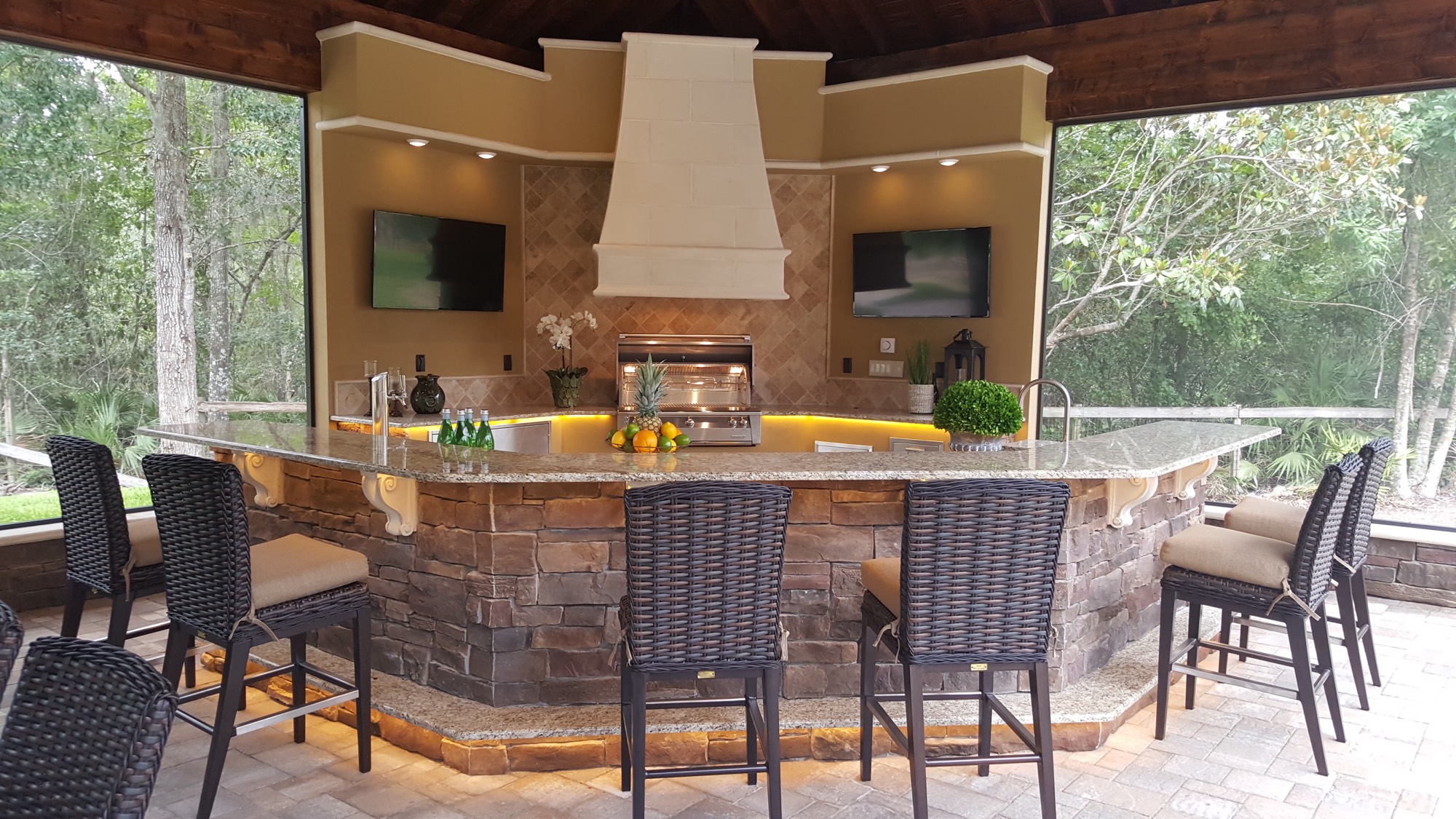 The detached outdoor structure across the pool from the home