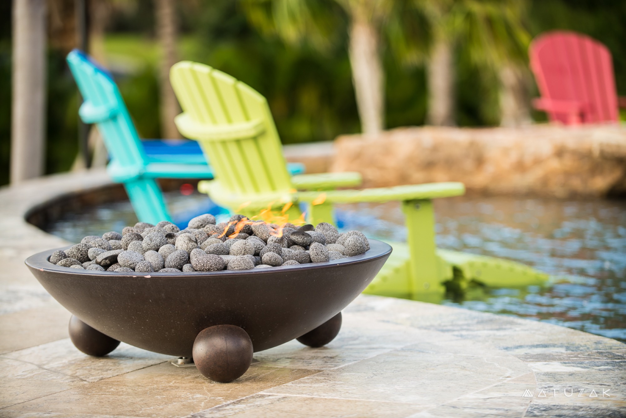 The firepit and adirondack seating area at the Merritt Island waterfront home