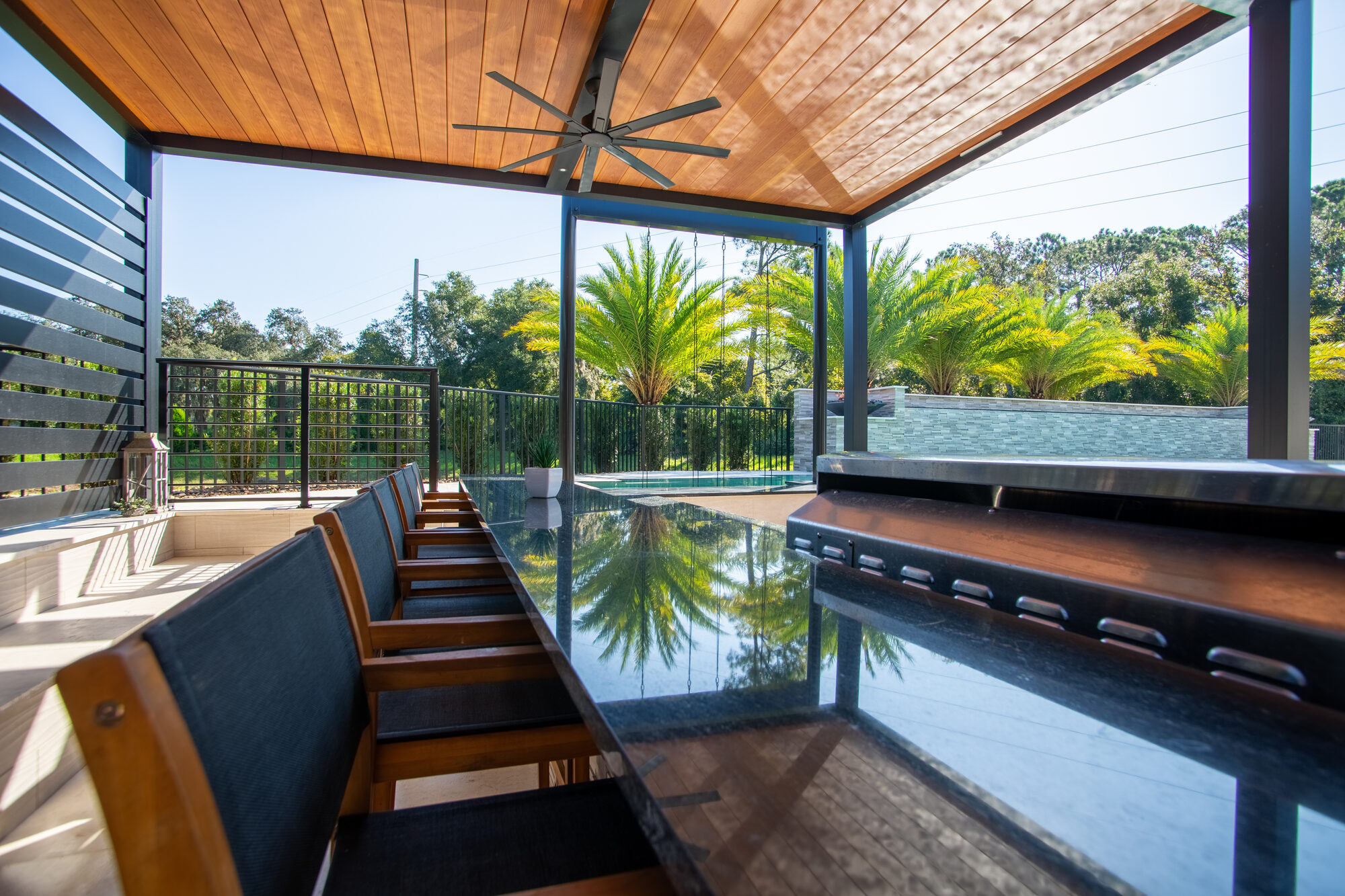 Louvered pergola shading the poolside living space in New Smyrna Beach, FL